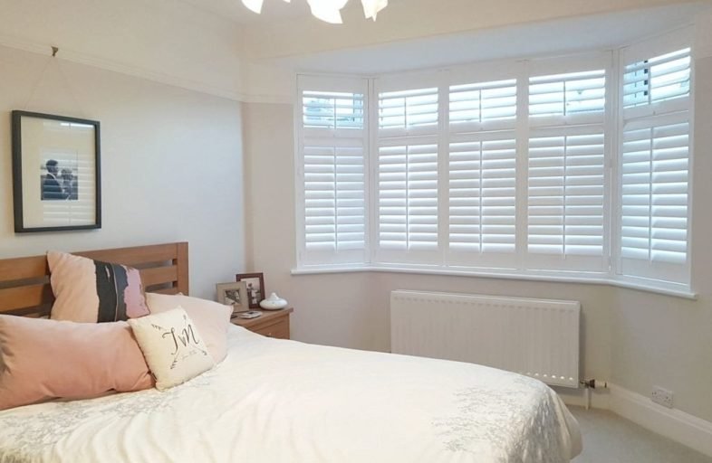 White shutters on a bedroom bay window