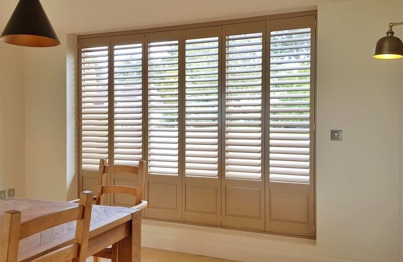 Full-height shutters in a dining room